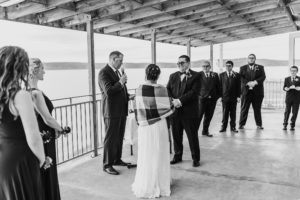 black and white of wedding ceremony over looking the water
