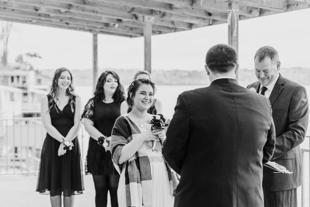 Bride laughs at groom during wedding ceremony