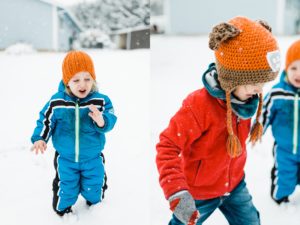 Brothers run through the snow in their backyard