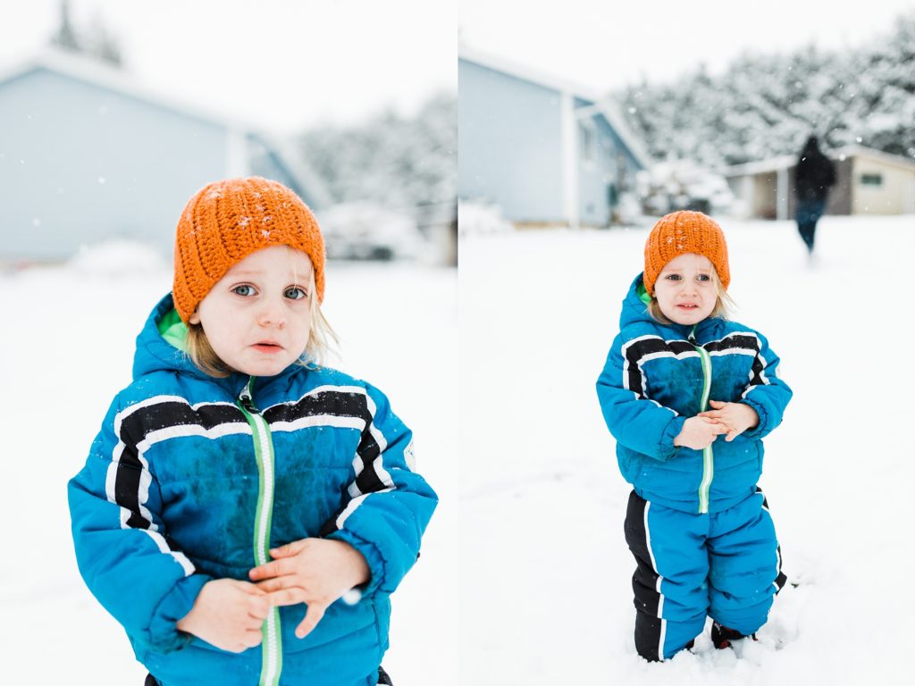 two year old looks sad and cold in the snow