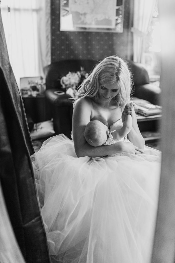 Breastfeeding Bride in reflection of Bridal Suite Mirror