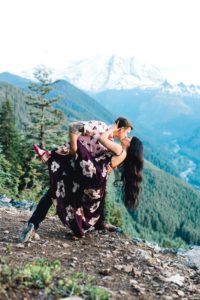 Couple dancing on mountain with Mt. Rainier and river in the backdrop.