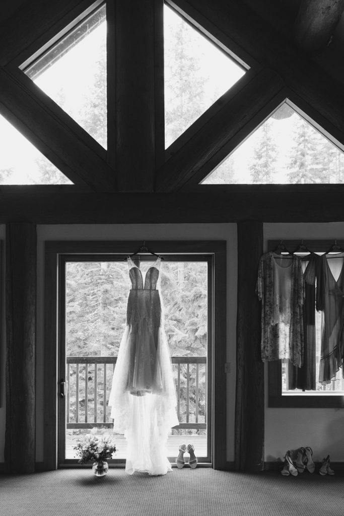 Wedding Dress hanging back lit in door frame