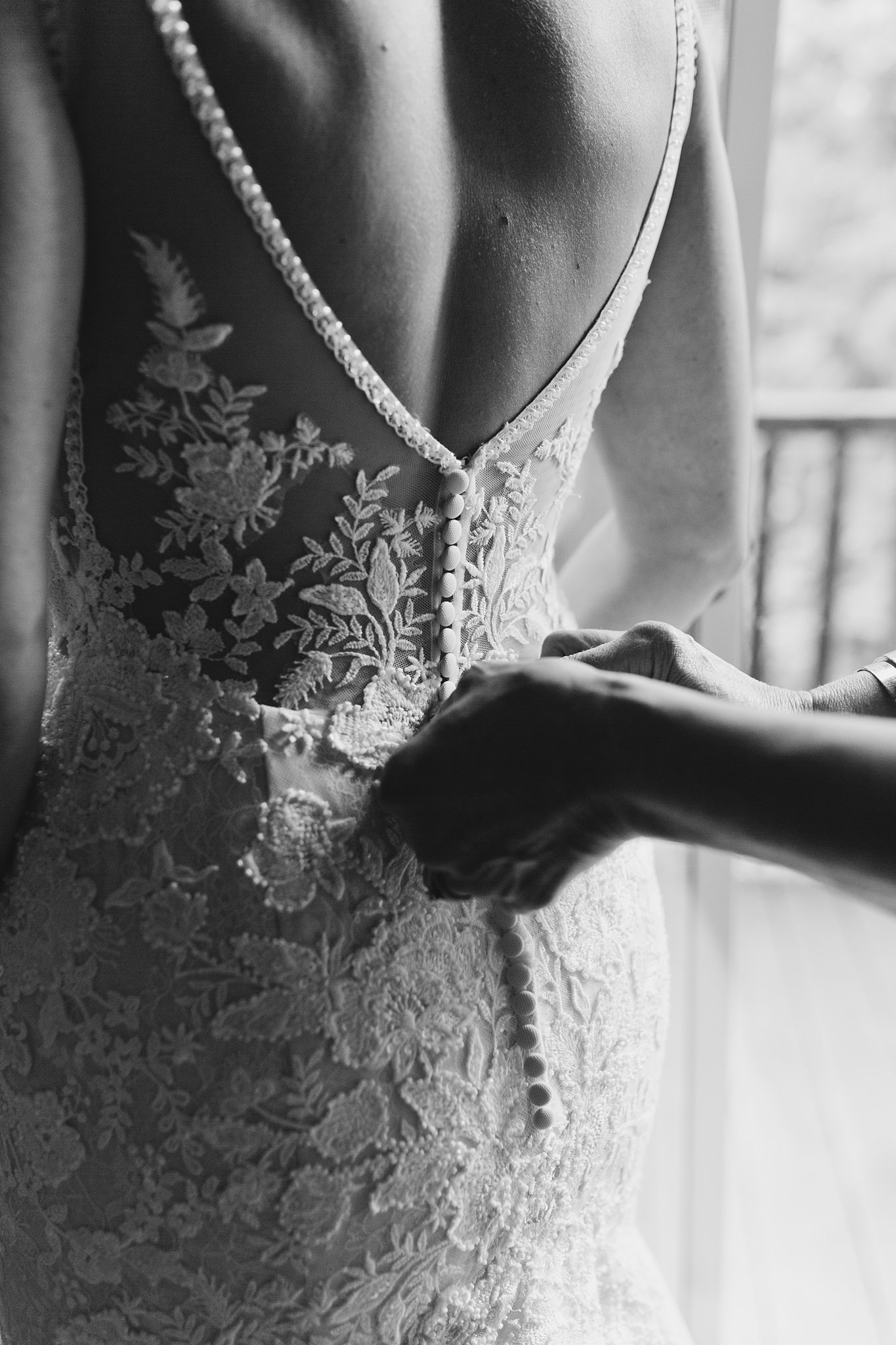 Bride's dress being buttoned